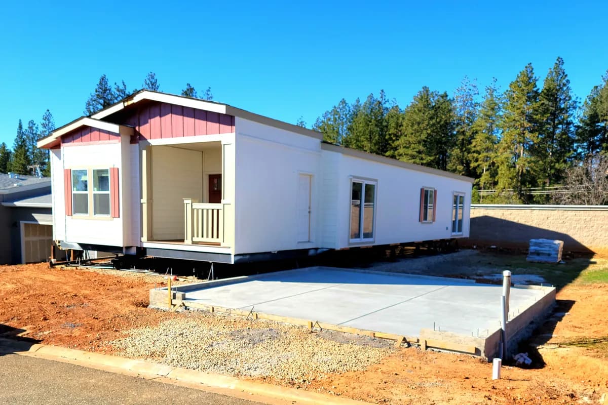 Manufactured home raised on foundation supports — earthquake bracing and pier work context for Kern County